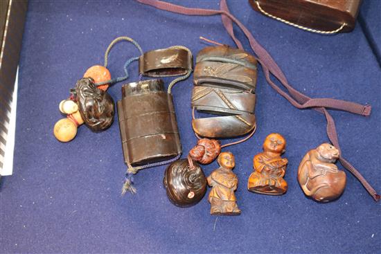 A group of inros and netsuke and two Japanese sword fittings